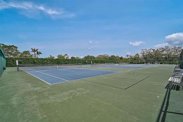 view of tennis court featuring fence and community basketball court