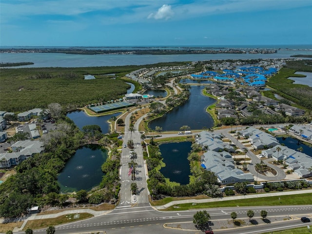 aerial view of property and surrounding area with a nearby body of water and nearby suburban area