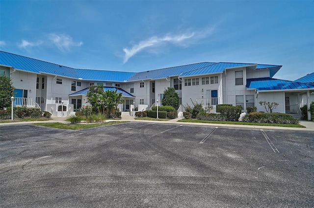 view of property with uncovered parking and a residential view