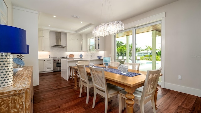 603 Emerald Ln, Holmes Beach, FL 34217 - dining area with dark wood-style flooring, a chandelier, baseboards, recessed lighting, and a raised ceiling
