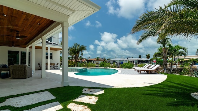 603 Emerald Ln, Holmes Beach, FL 34217 - view of swimming pool with a ceiling fan, a lawn, a patio area, and a pool with connected hot tub