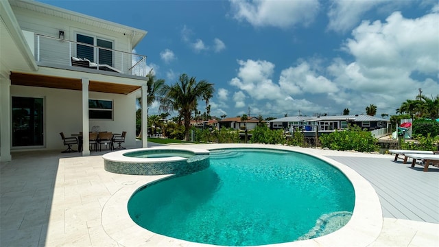 603 Emerald Ln, Holmes Beach, FL 34217 - view of swimming pool featuring a patio, a pool with connected hot tub, outdoor dining area, and a residential view