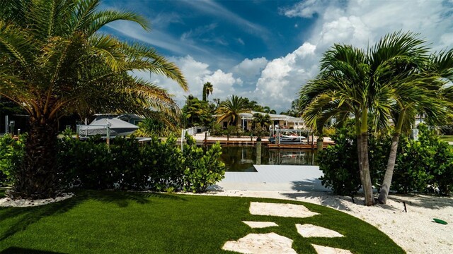 603 Emerald Ln, Holmes Beach, FL 34217 - view of grassy yard with a dock
