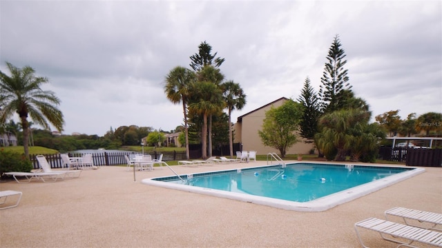 community pool featuring a patio area and fence