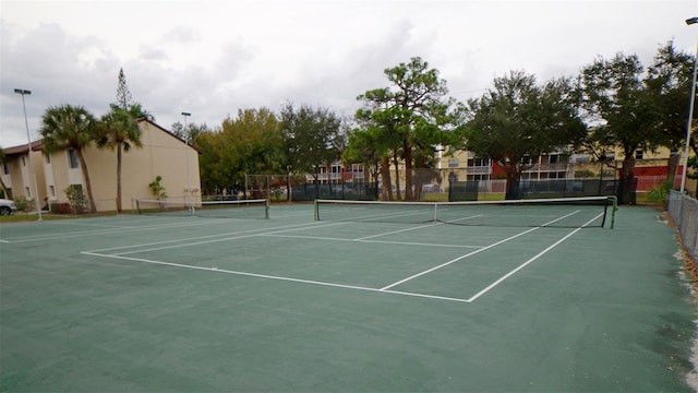 view of tennis court with fence