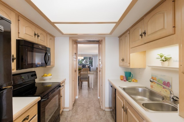 kitchen featuring black appliances, a sink, light brown cabinets, and light countertops