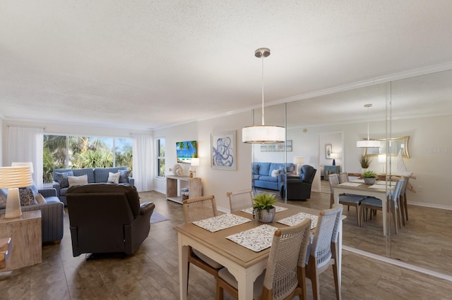 dining room featuring ornamental molding and baseboards