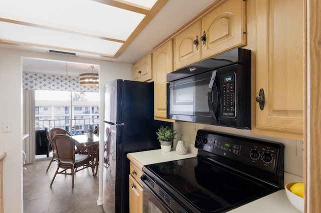 kitchen with black appliances, light brown cabinets, and light countertops