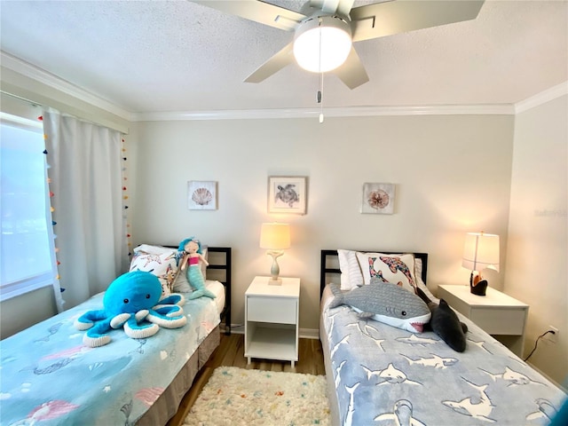 bedroom with wood finished floors, ornamental molding, baseboards, and a ceiling fan