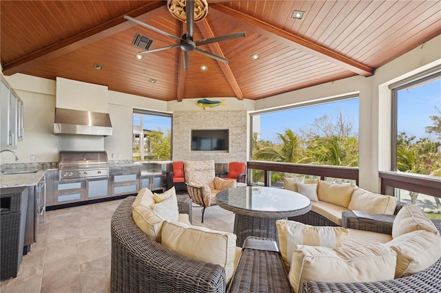 sunroom featuring plenty of natural light and a sink