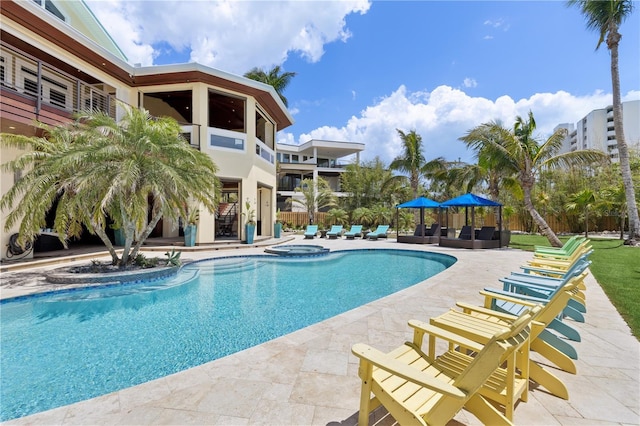 view of swimming pool with a patio and a pool with connected hot tub