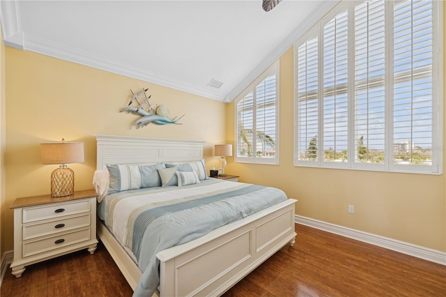 bedroom featuring baseboards, dark wood-style flooring, ornamental molding, and vaulted ceiling