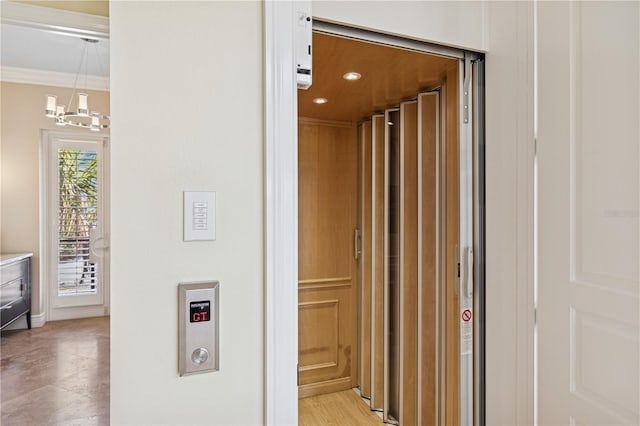 corridor with ornamental molding, elevator, a chandelier, and recessed lighting