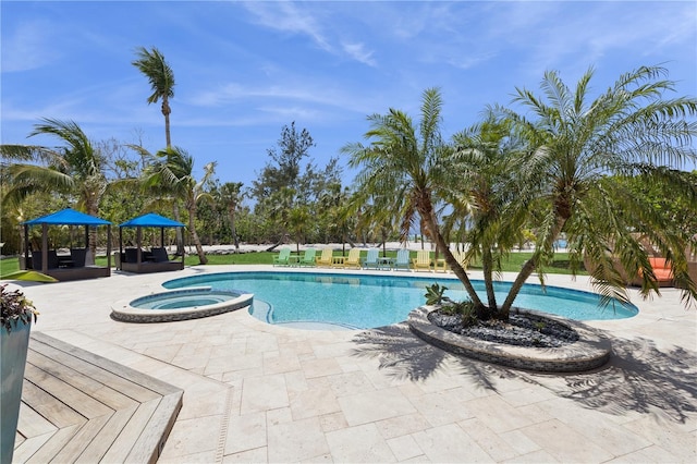 view of pool featuring a patio area and a pool with connected hot tub