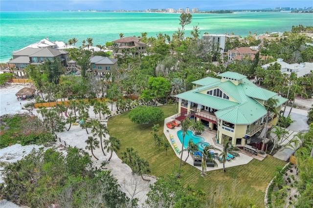 bird's eye view of a nearby body of water and a pool
