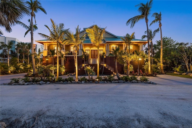 view of front of property featuring stairway and a porch