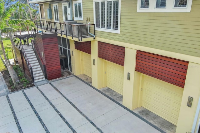 exterior space featuring an attached garage and stairway