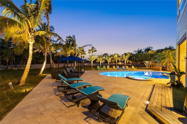 view of pool with a patio area and a pool with connected hot tub