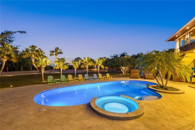 view of pool with a patio area and a pool with connected hot tub