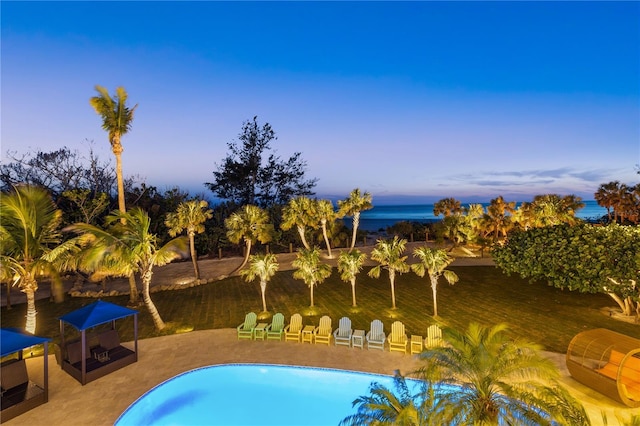 swimming pool with a patio and a water view