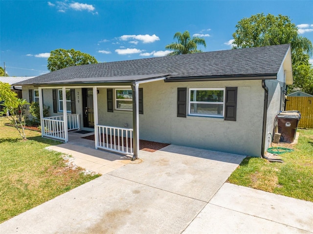 219 Vermont Ave, Saint Cloud, FL 34769 - view of front of house with a porch, a shingled roof, and stucco siding