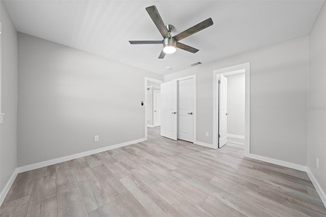 219 Vermont Ave, Saint Cloud, FL 34769 - unfurnished bedroom with light wood finished floors, baseboards, and a ceiling fan