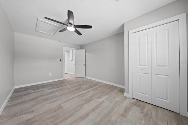 219 Vermont Ave, Saint Cloud, FL 34769 - unfurnished bedroom with attic access, light wood finished floors, baseboards, a closet, and ceiling fan
