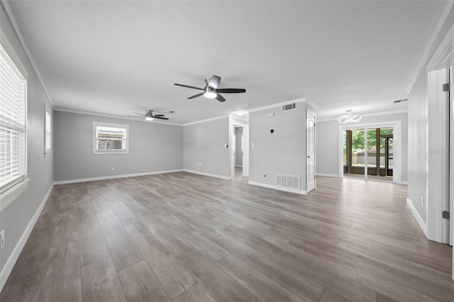 219 Vermont Ave, Saint Cloud, FL 34769 - unfurnished living room with ornamental molding, a ceiling fan, plenty of natural light, wood finished floors, and baseboards