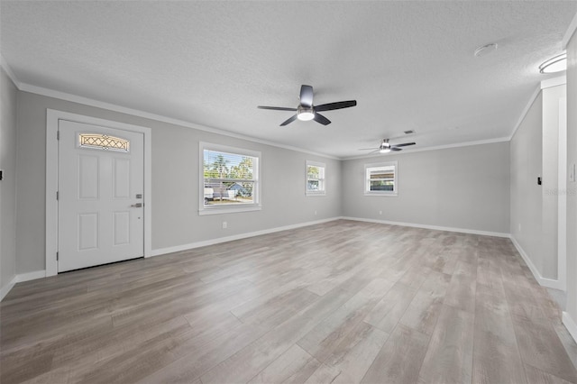 219 Vermont Ave, Saint Cloud, FL 34769 - foyer entrance with light wood finished floors, crown molding, ceiling fan, plenty of natural light, and a textured ceiling