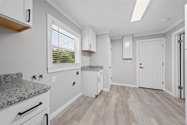 219 Vermont Ave, Saint Cloud, FL 34769 - clothes washing area with cabinet space, light wood-type flooring, baseboards, and washer hookup