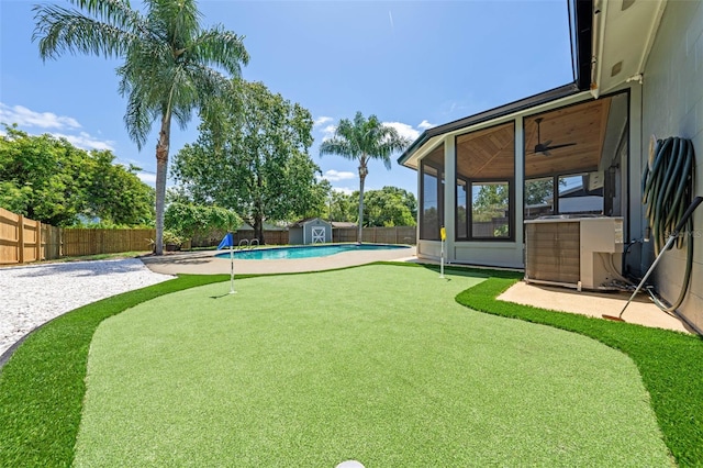 219 Vermont Ave, Saint Cloud, FL 34769 - fenced backyard featuring an area to practice putting, a shed, central AC unit, an outdoor structure, and a patio
