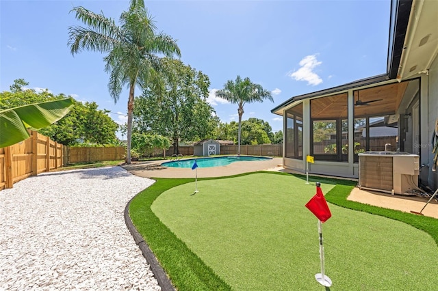 219 Vermont Ave, Saint Cloud, FL 34769 - view of community featuring a putting green, a shed, a fenced backyard, a swimming pool, and a patio