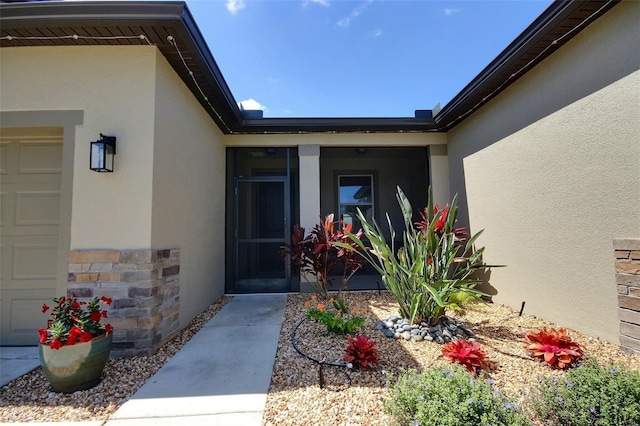 7311 64th St E, Palmetto, FL 34221 - doorway to property featuring stucco siding and stone siding