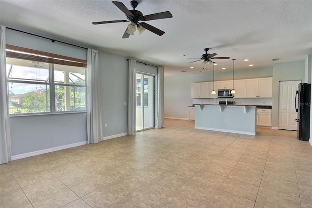 7311 64th St E, Palmetto, FL 34221 - unfurnished living room featuring a ceiling fan, a textured ceiling, recessed lighting, light tile patterned floors, and baseboards