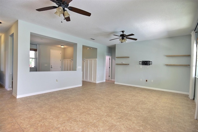 7311 64th St E, Palmetto, FL 34221 - unfurnished living room featuring a ceiling fan and a textured ceiling