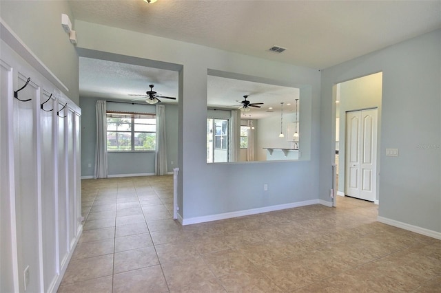 7311 64th St E, Palmetto, FL 34221 - unfurnished room featuring baseboards, a ceiling fan, light tile patterned floors, and a textured ceiling