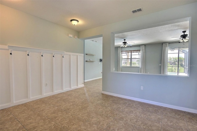 7311 64th St E, Palmetto, FL 34221 - spare room featuring ceiling fan, a textured ceiling, and tile patterned floors