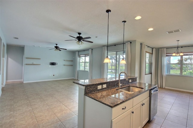 7311 64th St E, Palmetto, FL 34221 - kitchen featuring a sink, dishwasher, light tile patterned flooring, a center island with sink, and pendant lighting