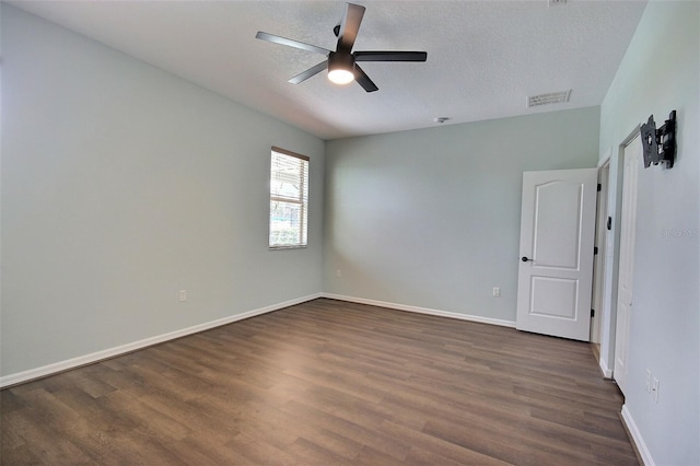 7311 64th St E, Palmetto, FL 34221 - unfurnished room featuring dark wood-style flooring, ceiling fan, baseboards, and a textured ceiling