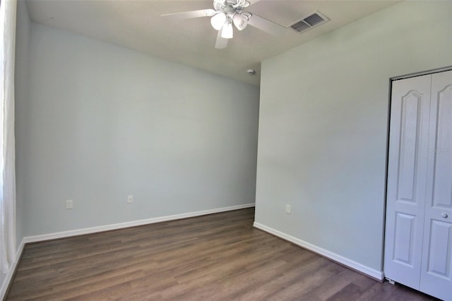 7311 64th St E, Palmetto, FL 34221 - unfurnished bedroom with dark wood-style floors, baseboards, a closet, and ceiling fan