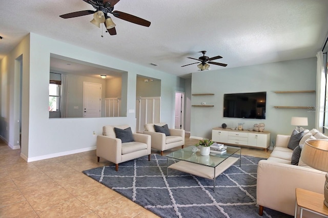 7311 64th St E, Palmetto, FL 34221 - tiled living room with a ceiling fan, a textured ceiling, and baseboards