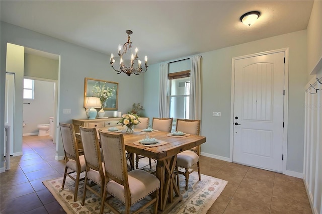 7311 64th St E, Palmetto, FL 34221 - dining room with a chandelier, light tile patterned floors, and baseboards