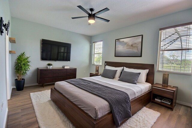 7311 64th St E, Palmetto, FL 34221 - bedroom with wood finished floors, baseboards, and a ceiling fan