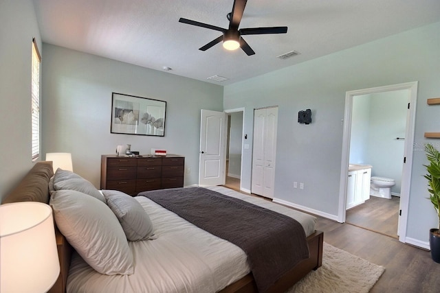7311 64th St E, Palmetto, FL 34221 - bedroom featuring wood finished floors, ensuite bath, baseboards, and a ceiling fan