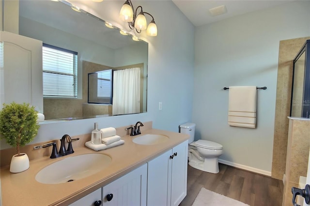 7311 64th St E, Palmetto, FL 34221 - full bathroom featuring a tile shower, wood finished floors, toilet, and double vanity
