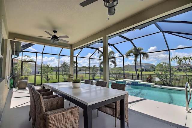 7311 64th St E, Palmetto, FL 34221 - view of patio featuring ceiling fan, a hot tub, glass enclosure, and fence