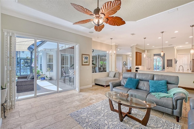 6539 Flycatcher Ln, Lakewood Ranch, FL 34202 - living area with a ceiling fan, plenty of natural light, baseboards, crown molding, and recessed lighting
