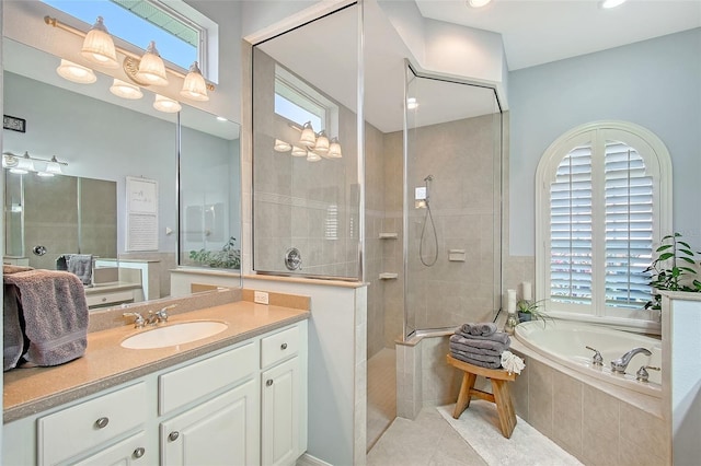 6539 Flycatcher Ln, Lakewood Ranch, FL 34202 - bathroom with plenty of natural light, a garden tub, tile patterned flooring, vanity, and recessed lighting