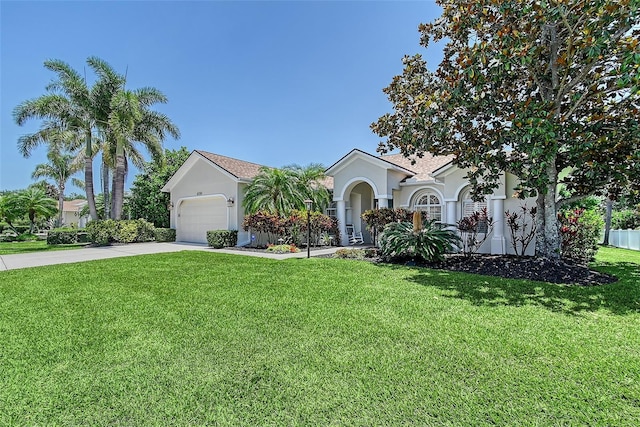 6539 Flycatcher Ln, Lakewood Ranch, FL 34202 - view of front of home with stucco siding, concrete driveway, an attached garage, and a front lawn