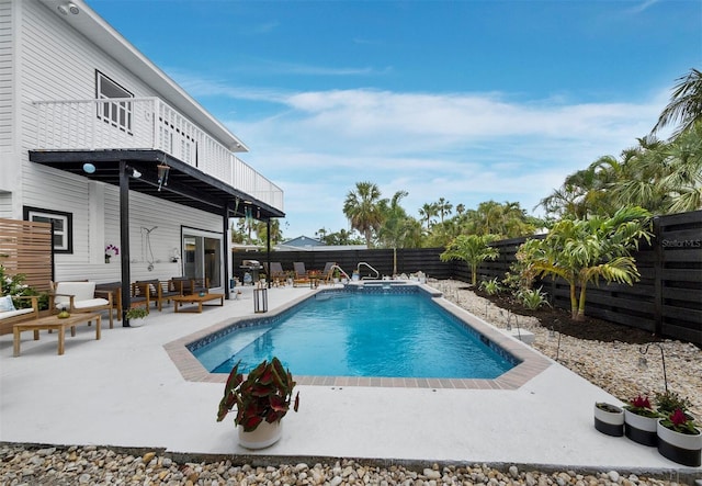 view of pool featuring a fenced backyard, a patio area, and a pool with connected hot tub